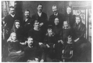 George and Emma Baker (centre) with their 12 children. William George is 2nd from left in the front. [Photograph courtesy John McNeil, ChCh]